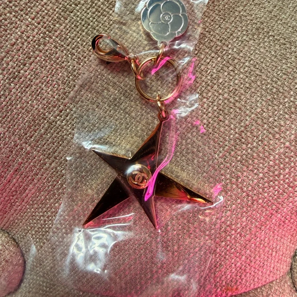 NWOT Authentic CHANEL Gold Star and Silver Camellia Flower Charm.